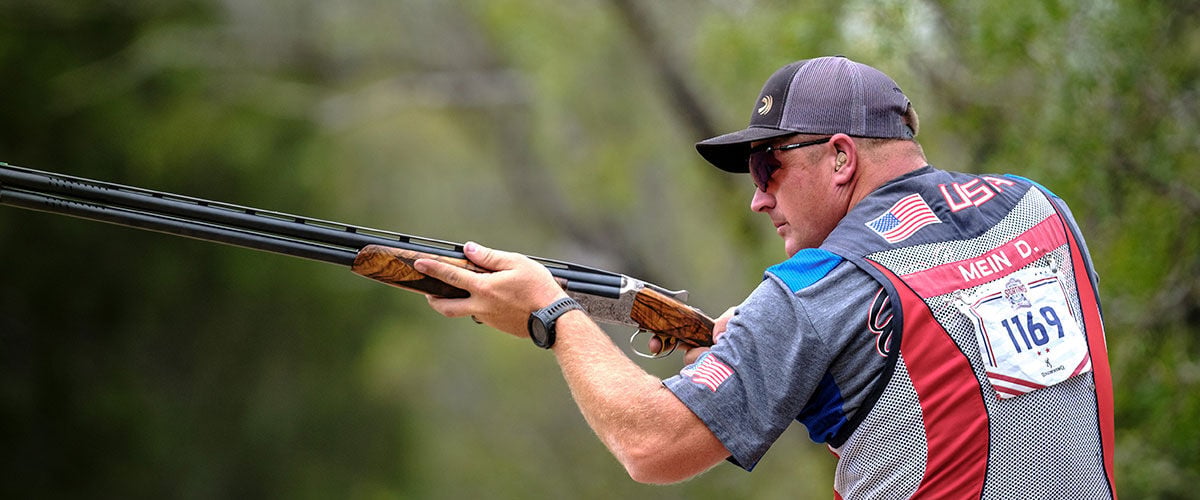 Derrick Mein holding a shotgun