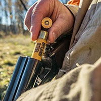 hunter loading Upland Steel into a shotgun